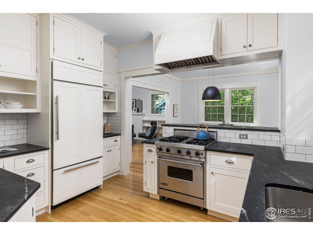 1064 10th Street Boulder, CO 80302 - Photo 6 of 40 a kitchen with white cabinets and white appliances