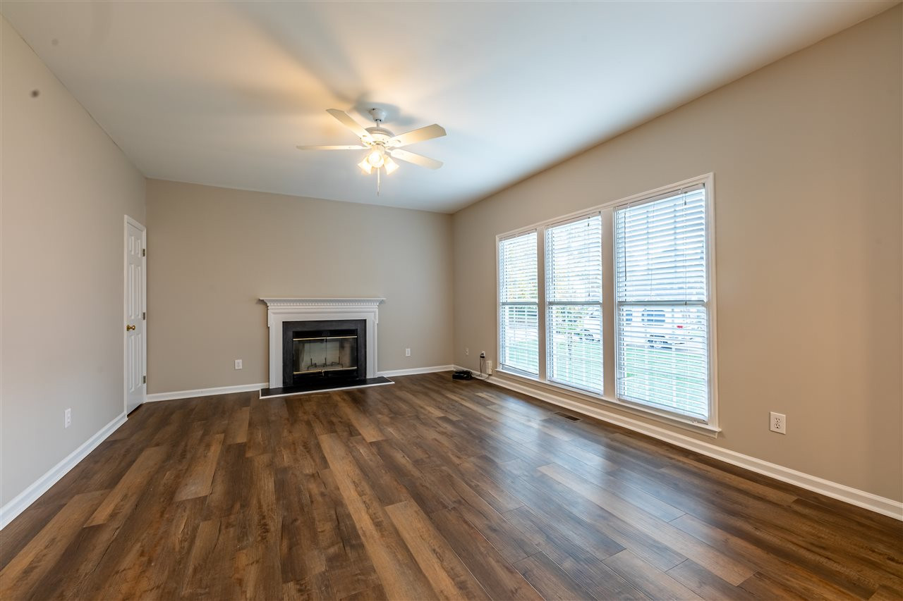 9212 Zermatt Court Raleigh, NC 27617 - Photo 11 of 30 Gas fireplace, ceiling fan and LVP flooring in the family room. Family Room