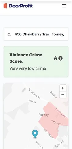 a front view of a house with garden and trees