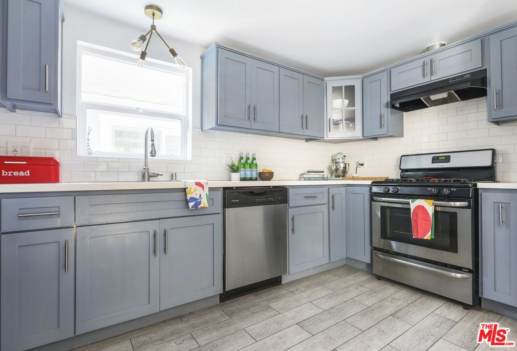 114 Hackett Place Los Angeles, CA 90042 - Photo 12 of 30 a kitchen with cabinets appliances a sink and a window