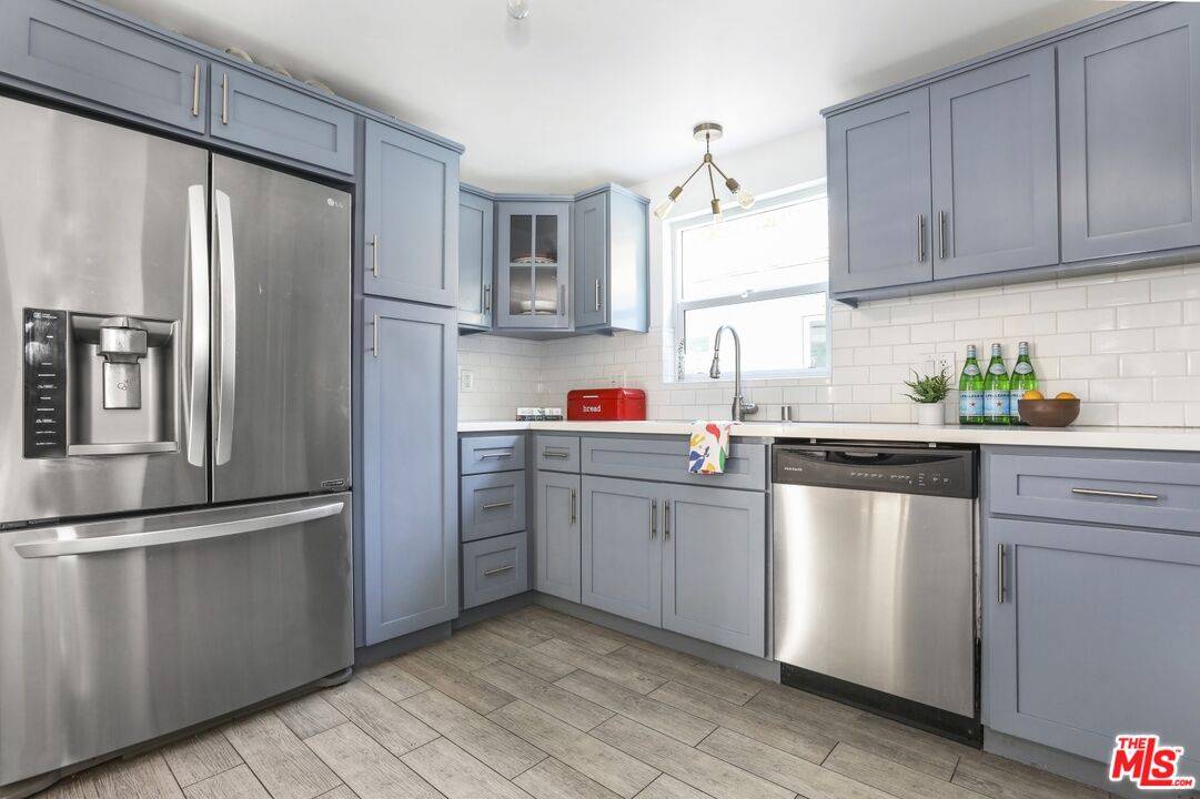 114 Hackett Place Los Angeles, CA 90042 - Photo 13 of 30 a kitchen with stainless steel appliances granite countertop a refrigerator sink and stove