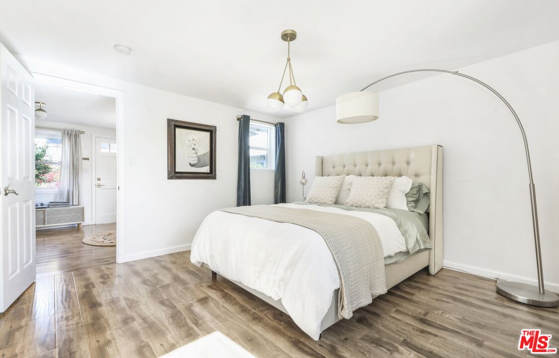 114 Hackett Place Los Angeles, CA 90042 - Photo 14 of 30 a bedroom with a bed and wooden floor