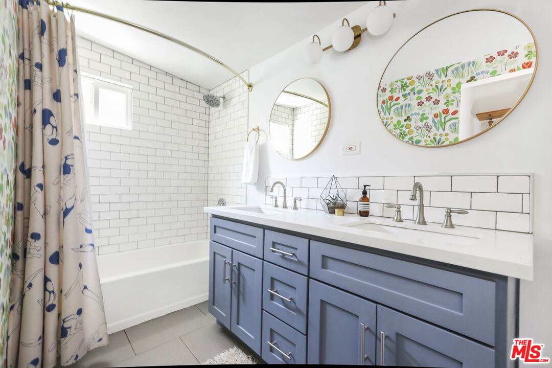 114 Hackett Place Los Angeles, CA 90042 - Photo 16 of 30 a bathroom with a double vanity sink and a mirror