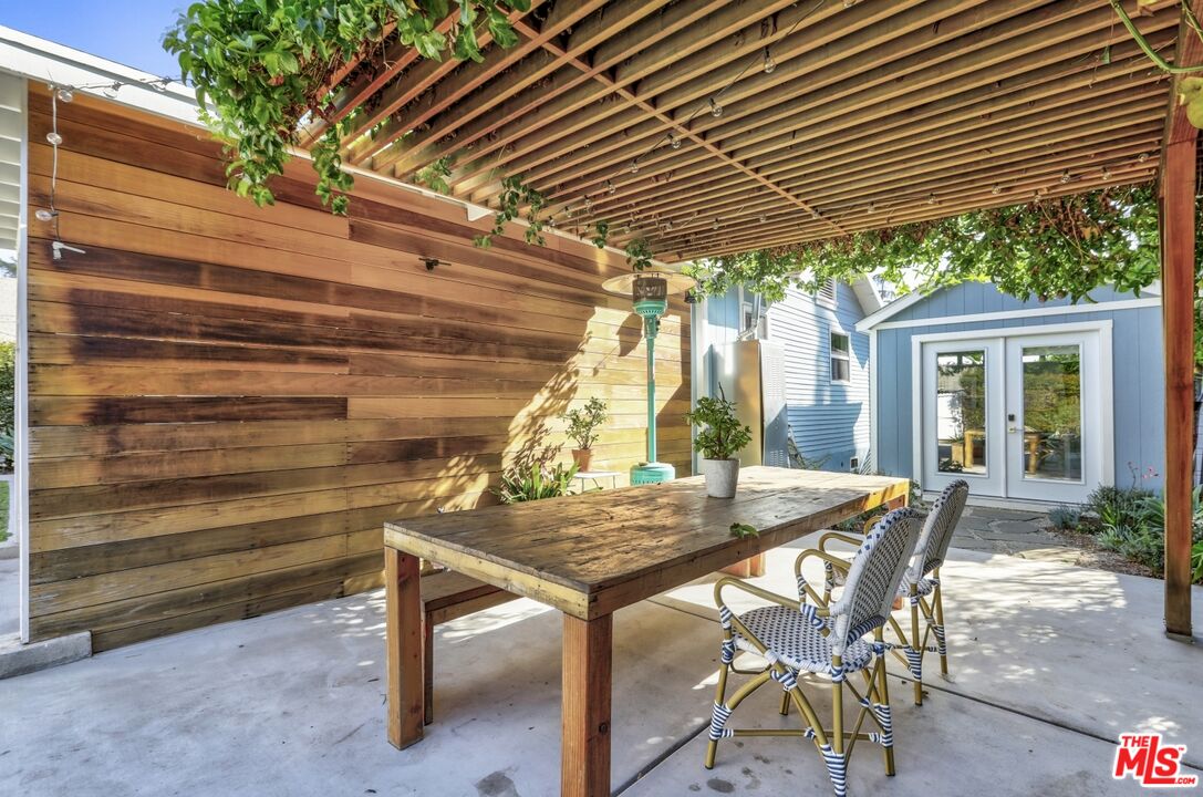 114 Hackett Place Los Angeles, CA 90042 - Photo 24 of 30 a view of patio with table and chairs under an umbrella
