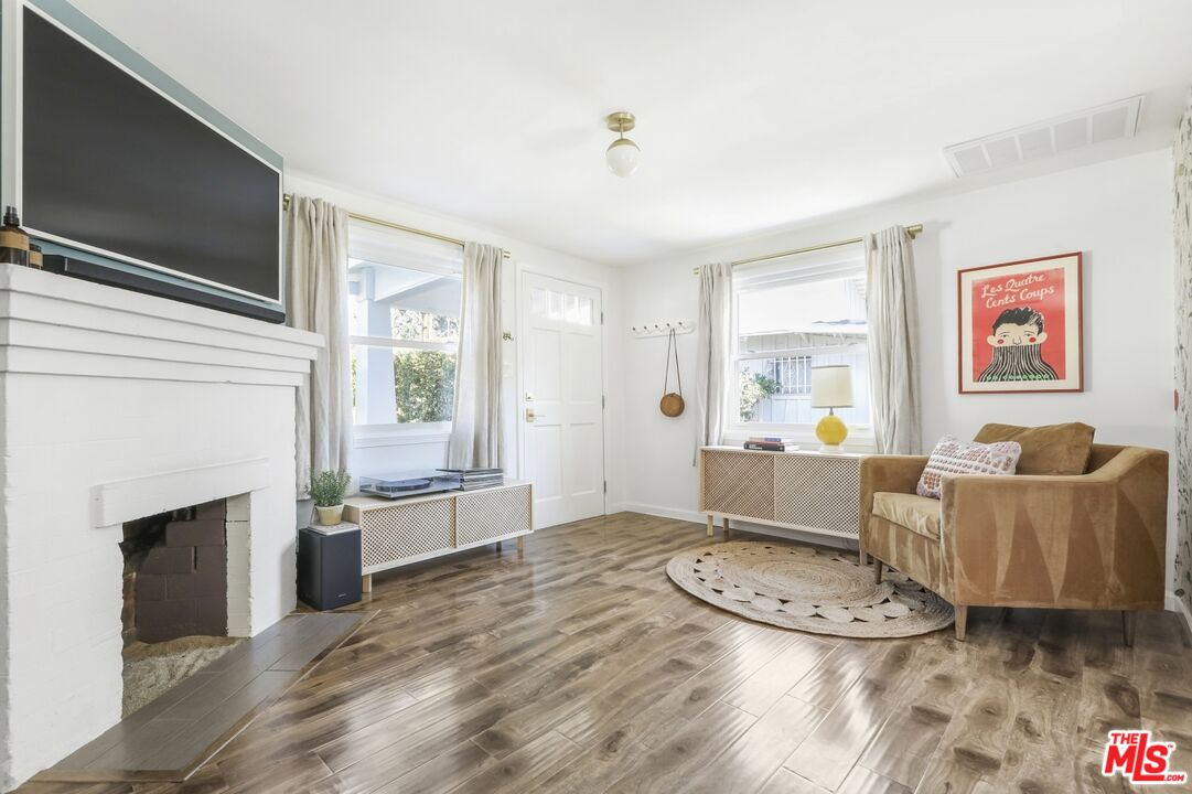 114 Hackett Place Los Angeles, CA 90042 - Photo 8 of 30 a living room with furniture and a fireplace