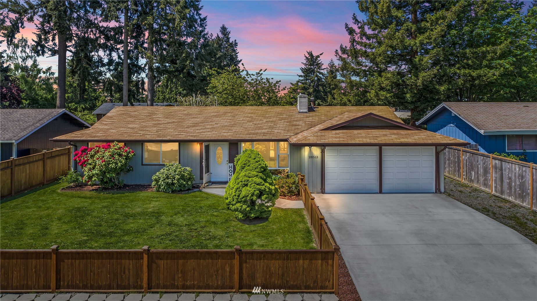 a front view of a house with a yard and garage