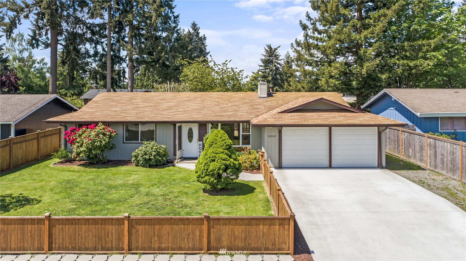 28513 24th Avenue South Federal Way, WA 98003 - Photo 2 of 31 a front view of a house with a yard and garage