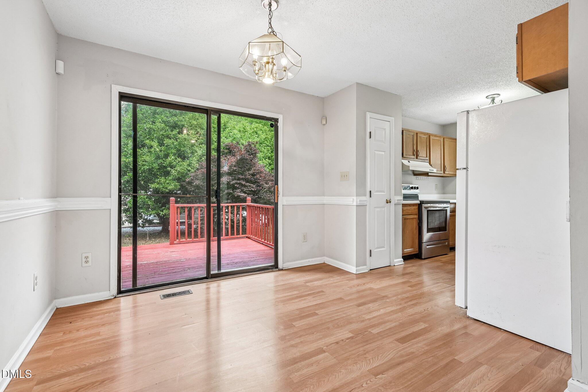2800 West Jameson Road Raleigh, NC 27604 - Photo 6 of 24 a view of a kitchen with wooden floor and electronic appliances