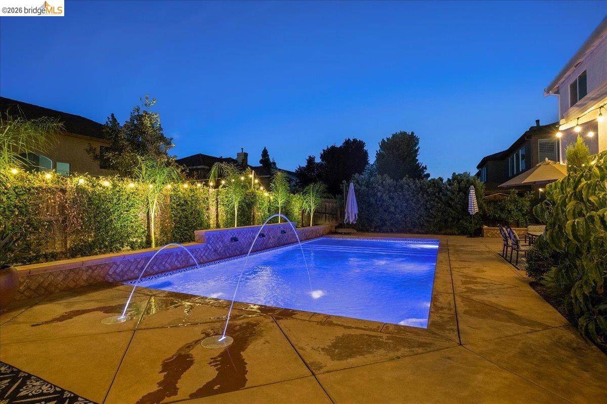 653 Bouma Lane Ripon, CA 95366 - Photo 34 of 39 Rectangular swimming pool with integrated water features and submerged lighting