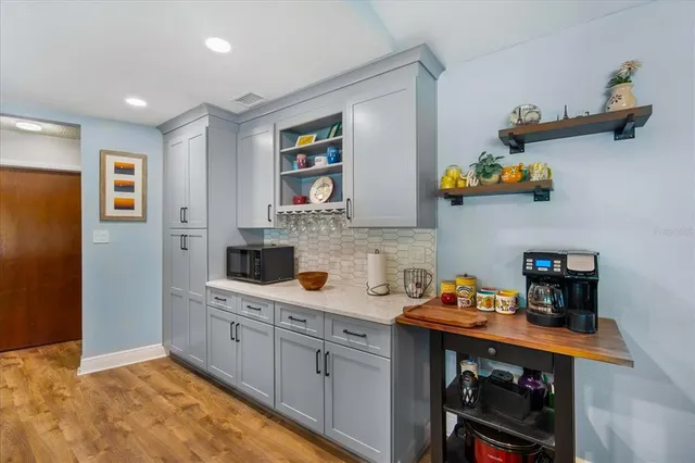 a kitchen with stainless steel appliances granite countertop a sink and cabinets