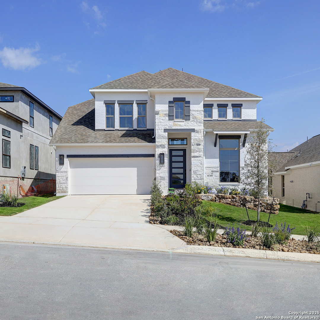 a front view of a house with a yard and garage