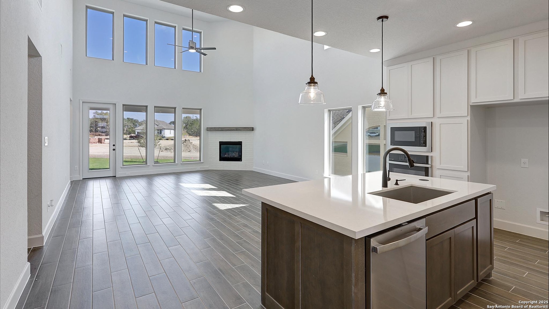 233 Hidalgo Boerne, TX 78006 - Photo 15 of 32 a kitchen with kitchen island granite countertop a sink and refrigerator