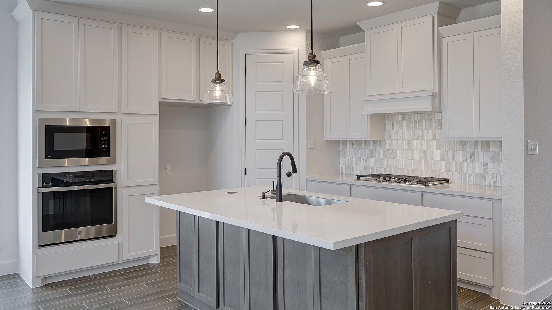 233 Hidalgo Boerne, TX 78006 - Photo 16 of 32 a kitchen with a sink stainless steel appliances and white cabinets