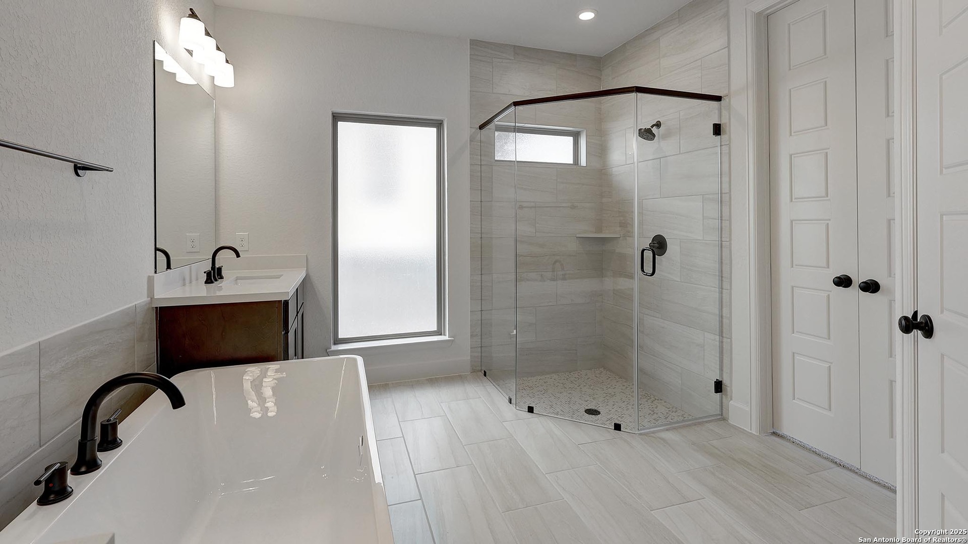 233 Hidalgo Boerne, TX 78006 - Photo 20 of 32 a bathroom with a bathtub and a shower