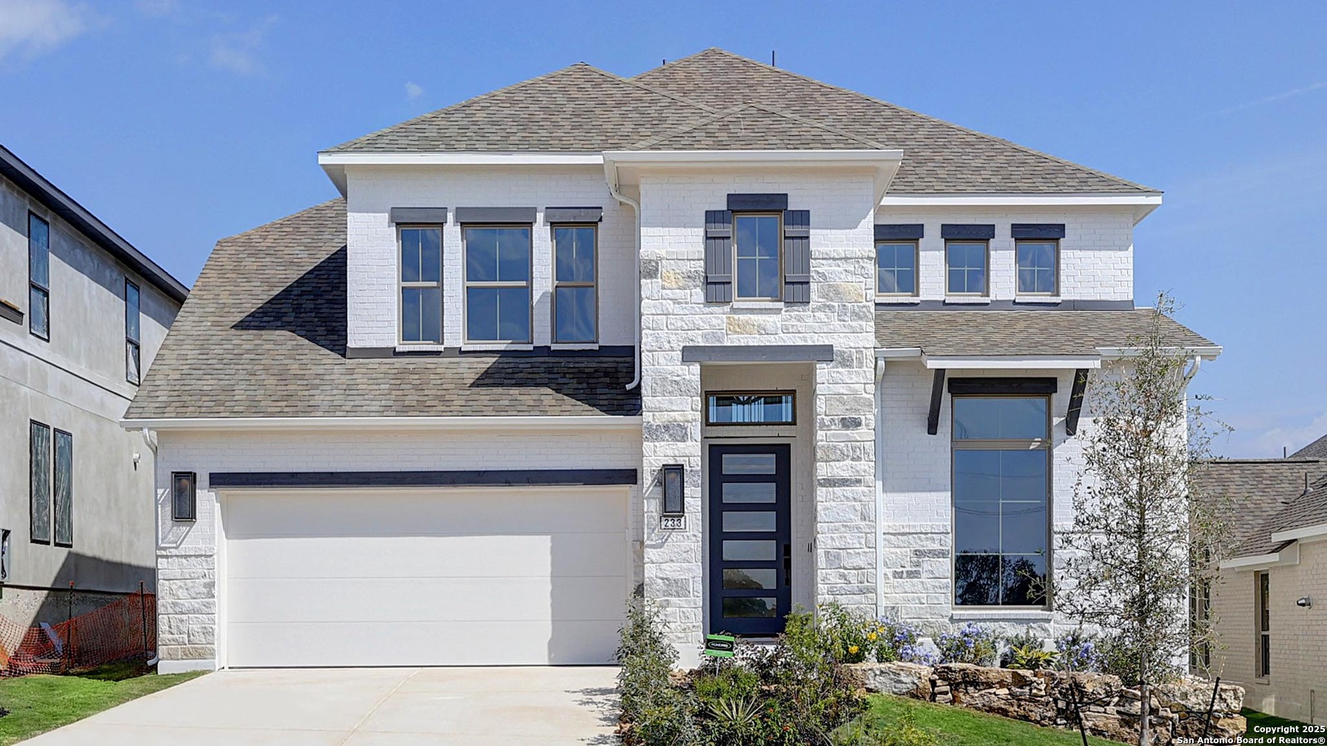 233 Hidalgo Boerne, TX 78006 - Photo 2 of 32 a front view of a house with a garage