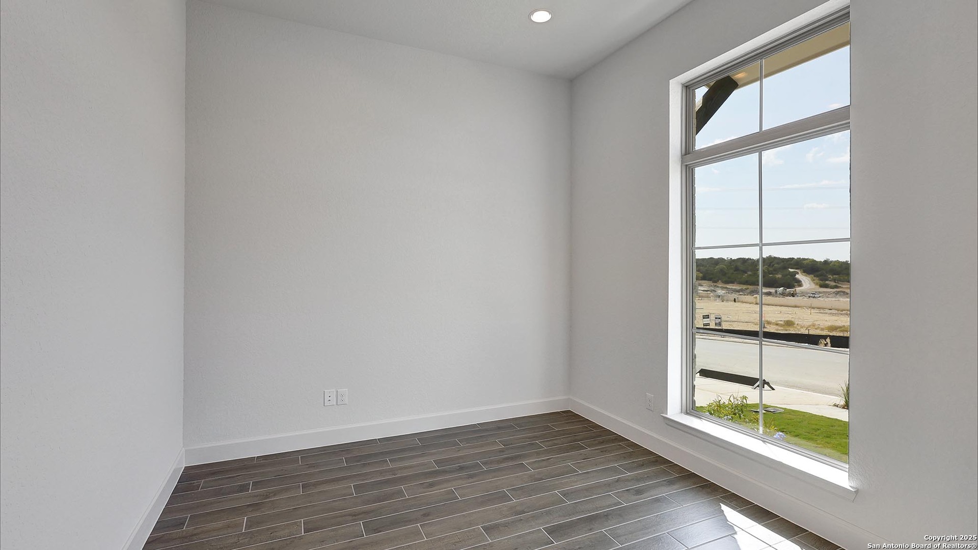 233 Hidalgo Boerne, TX 78006 - Photo 24 of 32 wooden floor in an empty room with a window