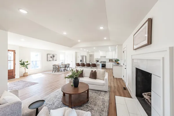 a living room with furniture a fireplace and a table
