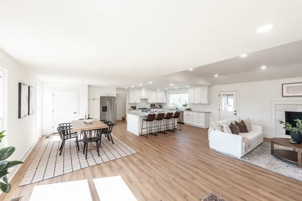 a view of a dining room with furniture and wooden floor
