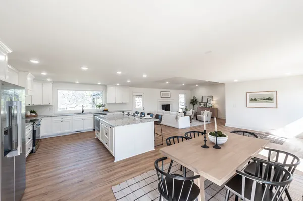 a kitchen with granite countertop kitchen island a counter space a sink appliances and cabinets