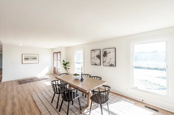 a kitchen with stainless steel appliances white cabinets and a window