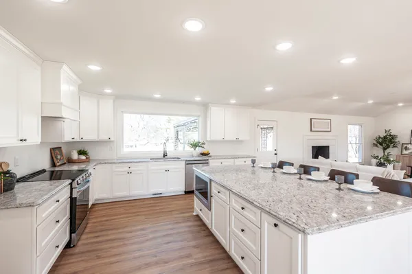 a large kitchen with a table and chairs