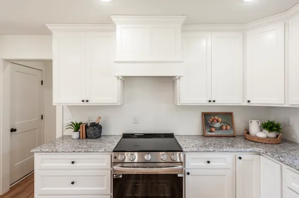 a kitchen with a dining table chairs and view living room