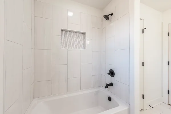 a bath tub sitting next to a shower