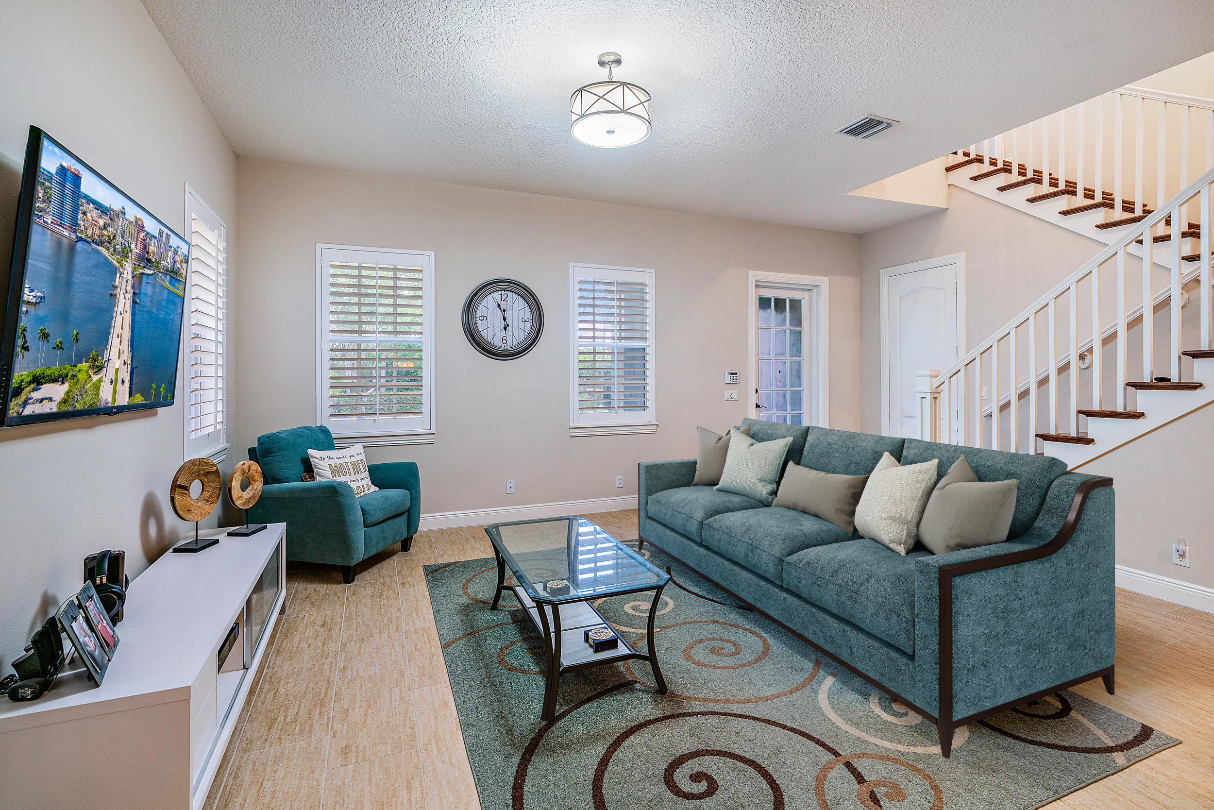 202 Botanica Drive Jupiter, FL 33458 - Photo 11 of 39 a living room with furniture and a clock