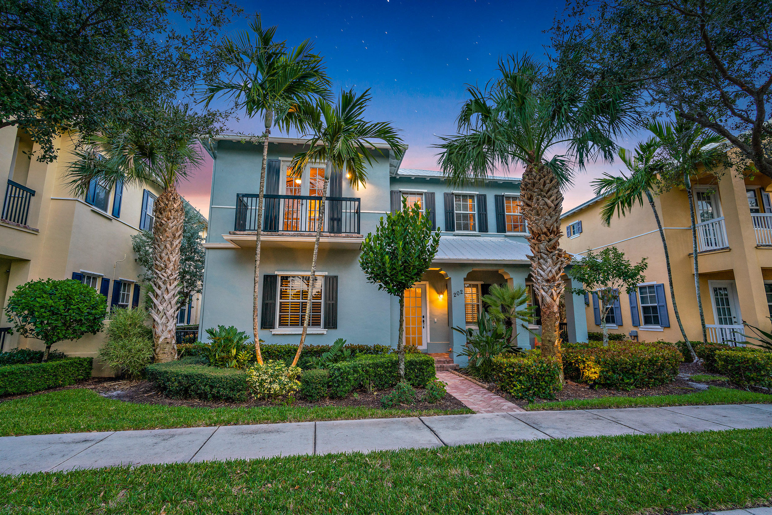 202 Botanica Drive Jupiter, FL 33458 - Photo 3 of 39 front view of a house with a yard