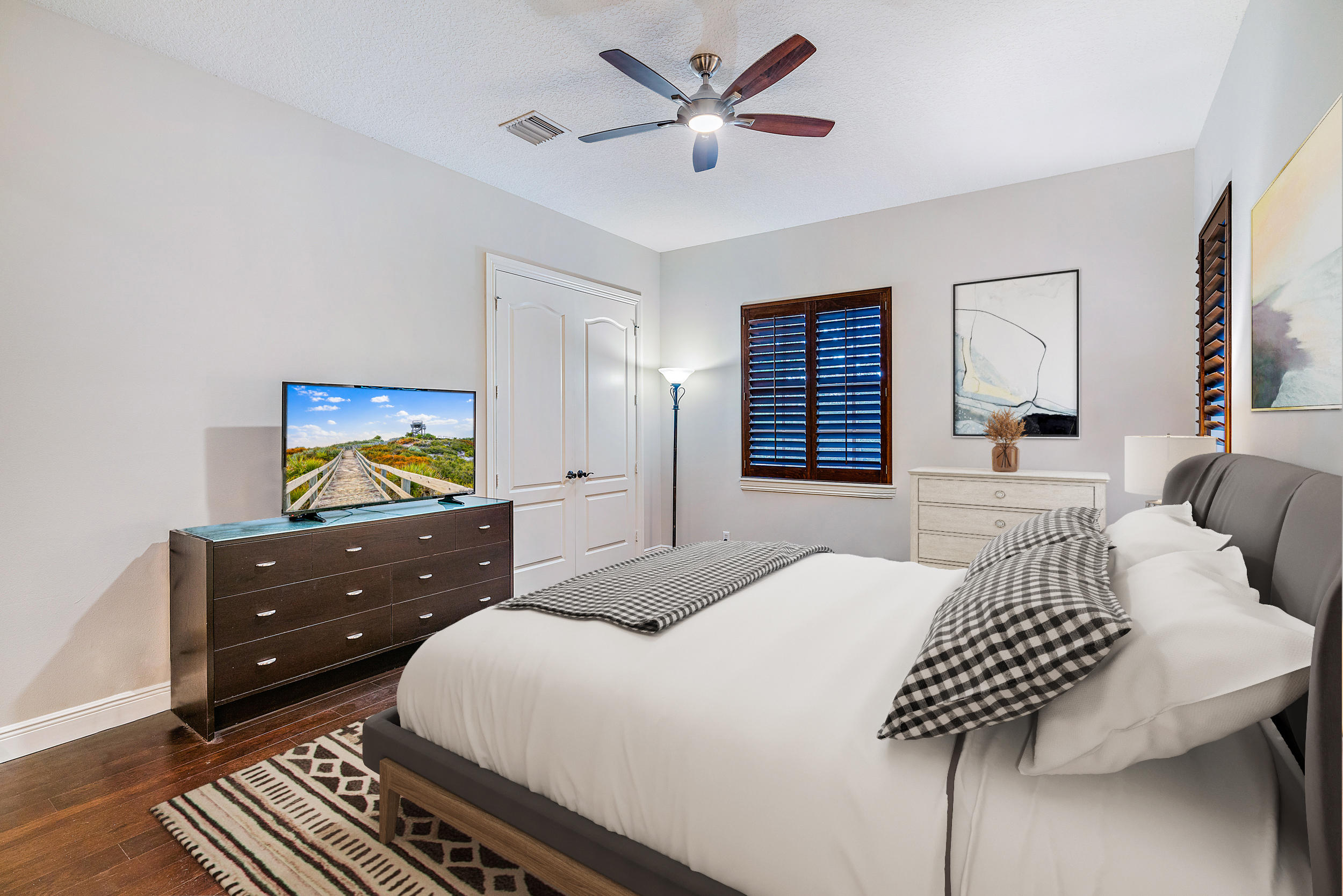 202 Botanica Drive Jupiter, FL 33458 - Photo 21 of 39 a bedroom with a bed and a dresser