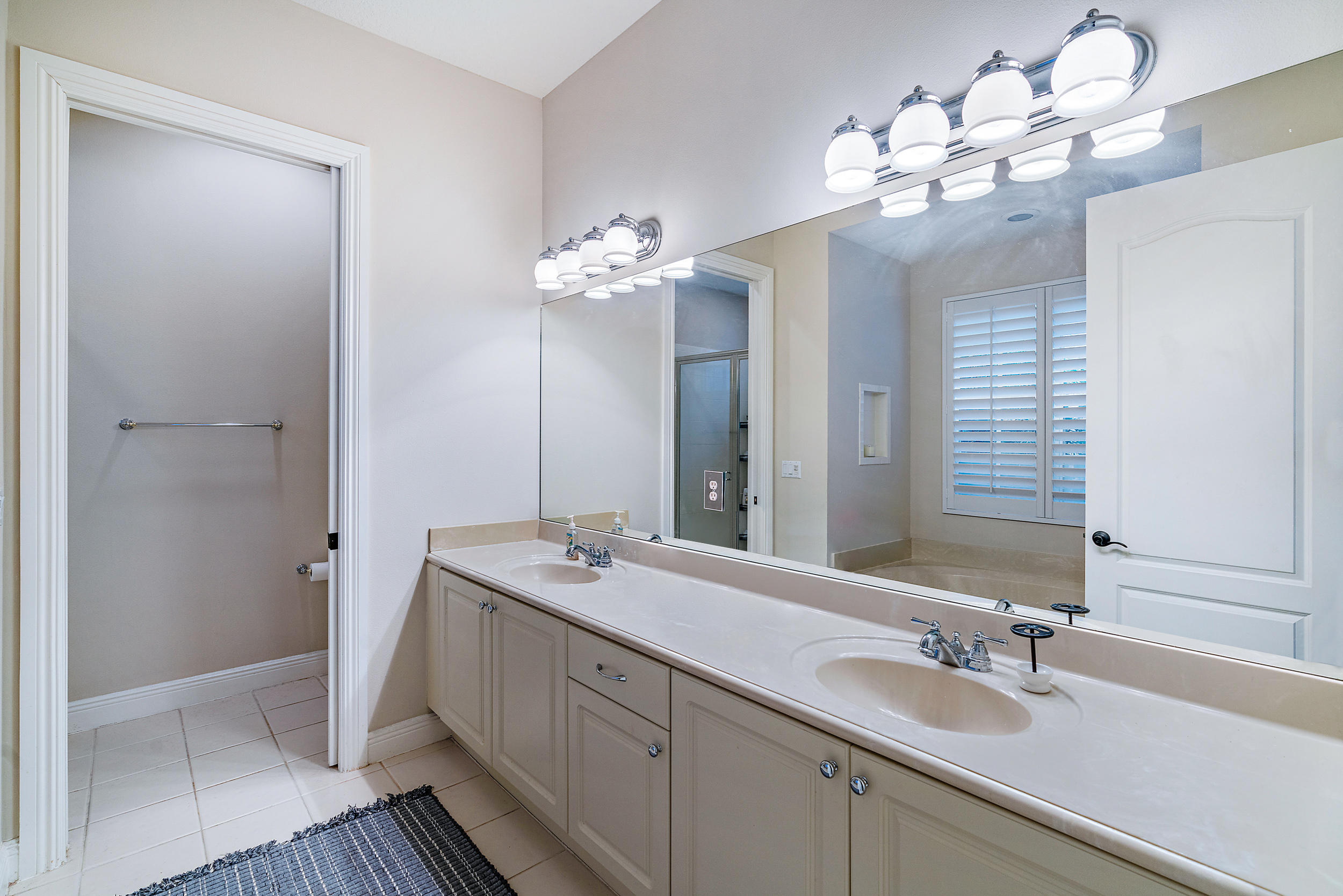 202 Botanica Drive Jupiter, FL 33458 - Photo 22 of 39 a bathroom with a double vanity sink and a mirror