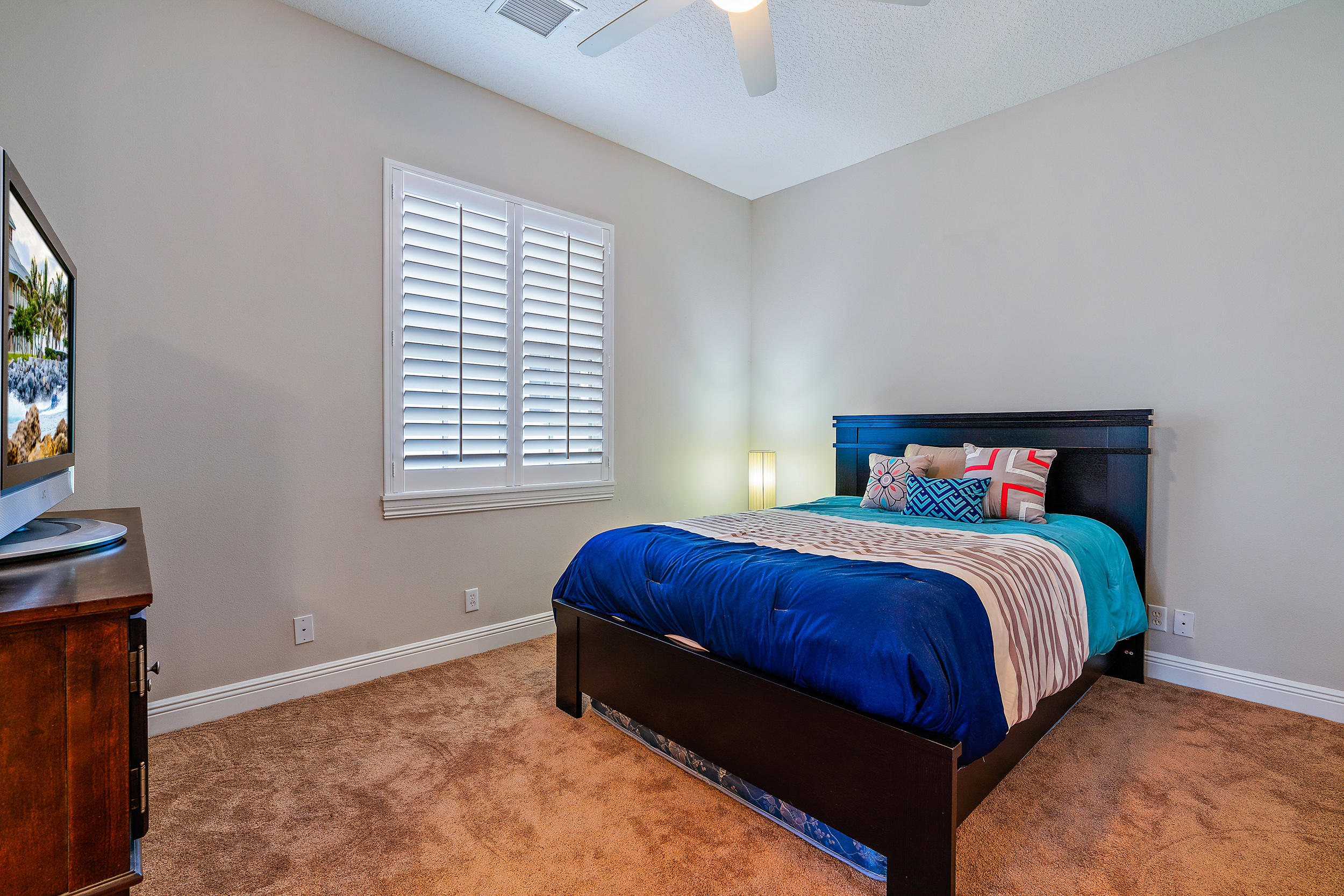 202 Botanica Drive Jupiter, FL 33458 - Photo 25 of 39 a bedroom with a bed and window