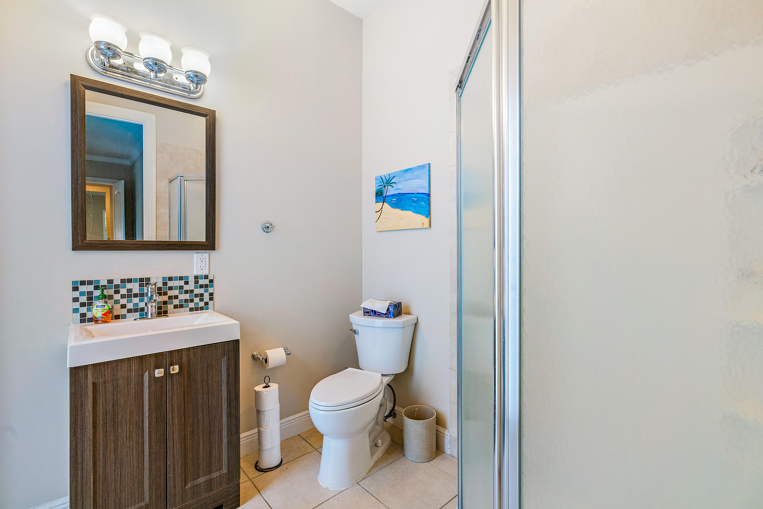 202 Botanica Drive Jupiter, FL 33458 - Photo 26 of 39 a bathroom with a toilet sink and mirror