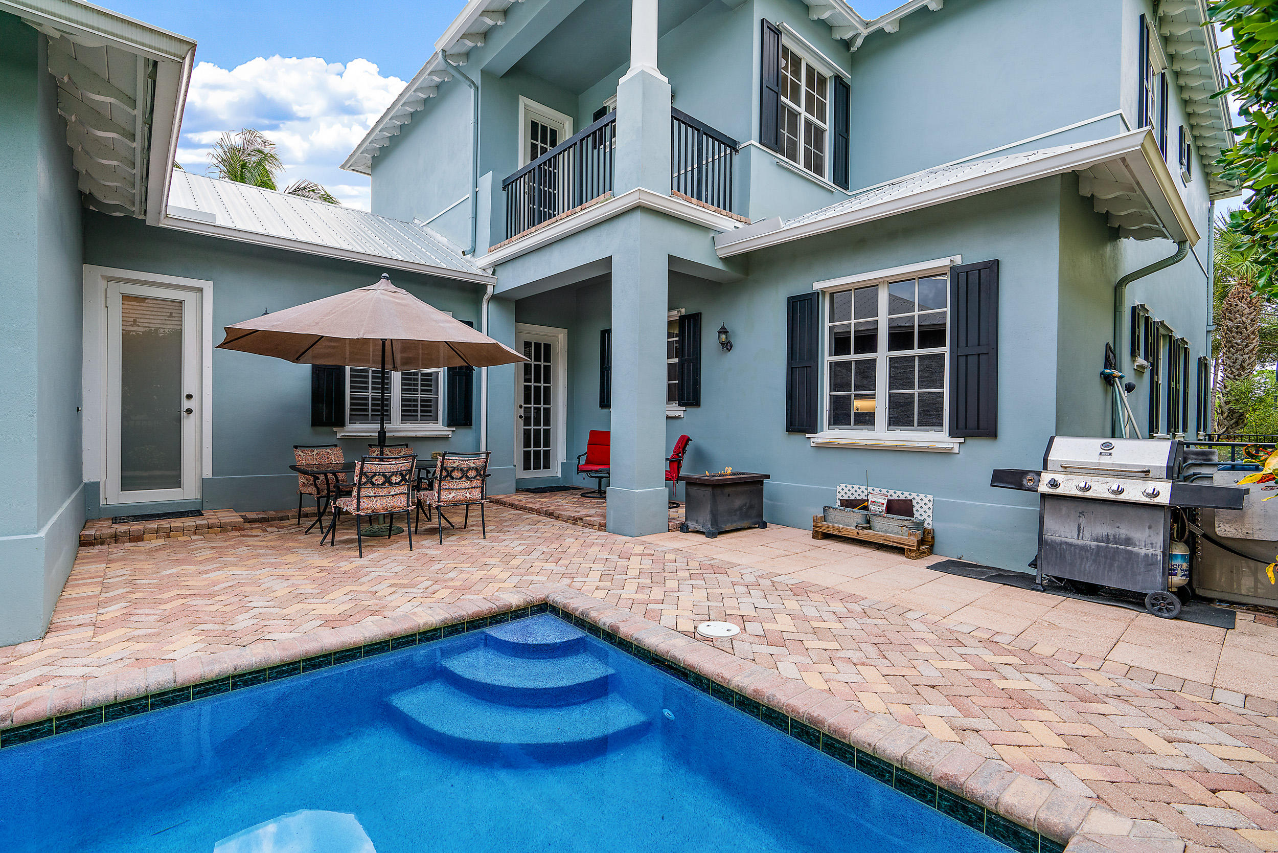202 Botanica Drive Jupiter, FL 33458 - Photo 28 of 39 a view of a house with chairs in patio