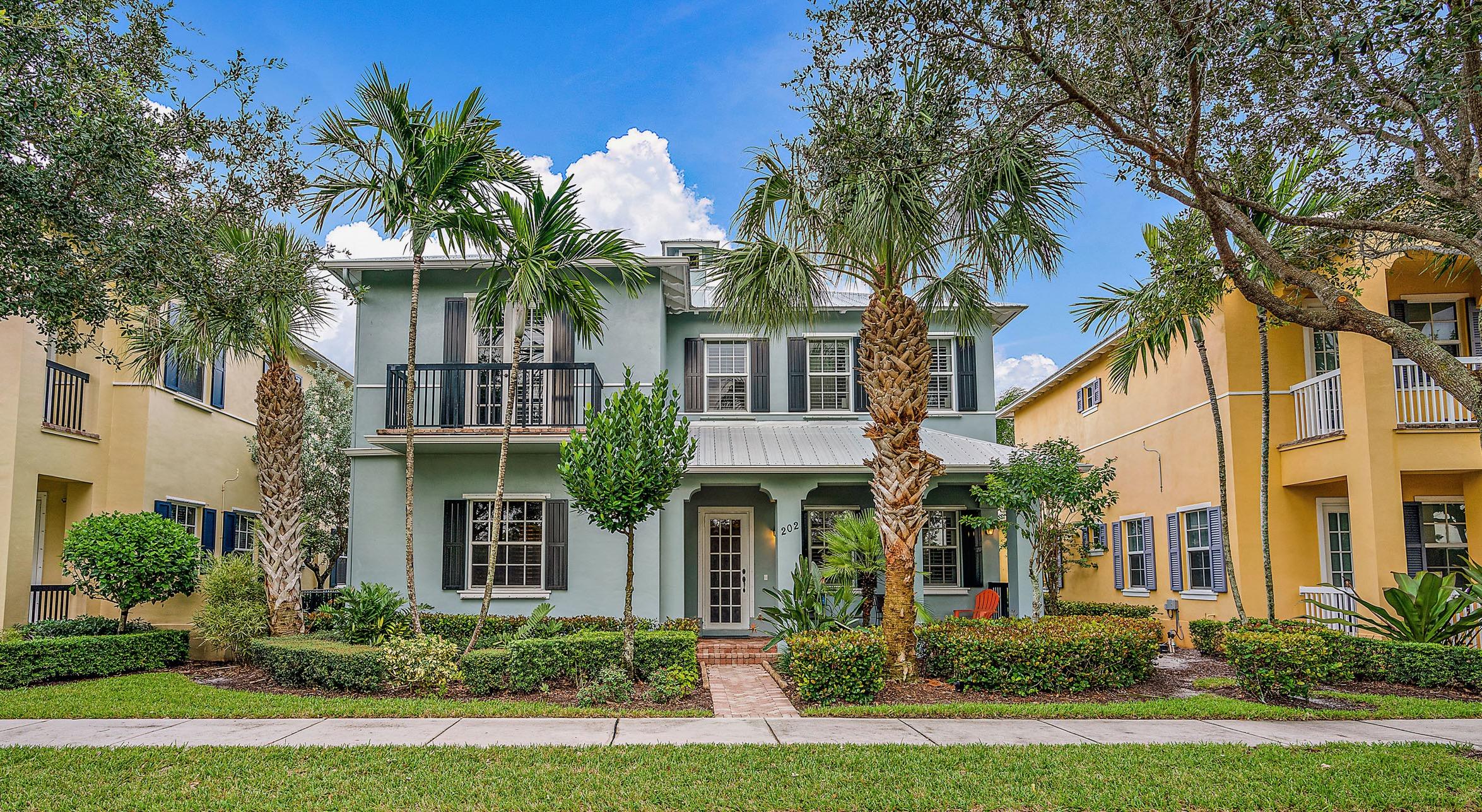 202 Botanica Drive Jupiter, FL 33458 - Photo 30 of 39 front view of a white house with a yard