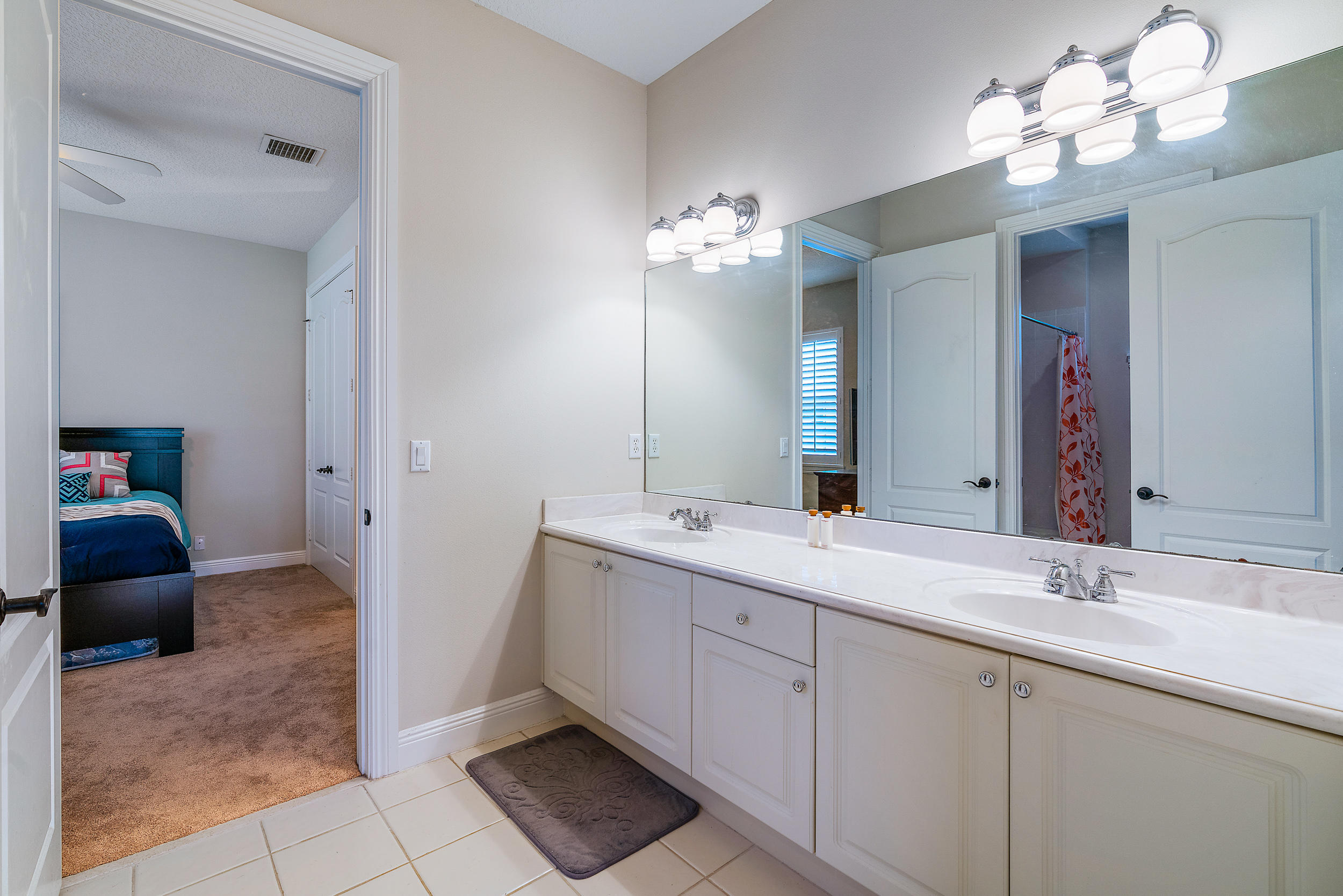202 Botanica Drive Jupiter, FL 33458 - Photo 32 of 39 a spacious bathroom with a double vanity sink and a mirror