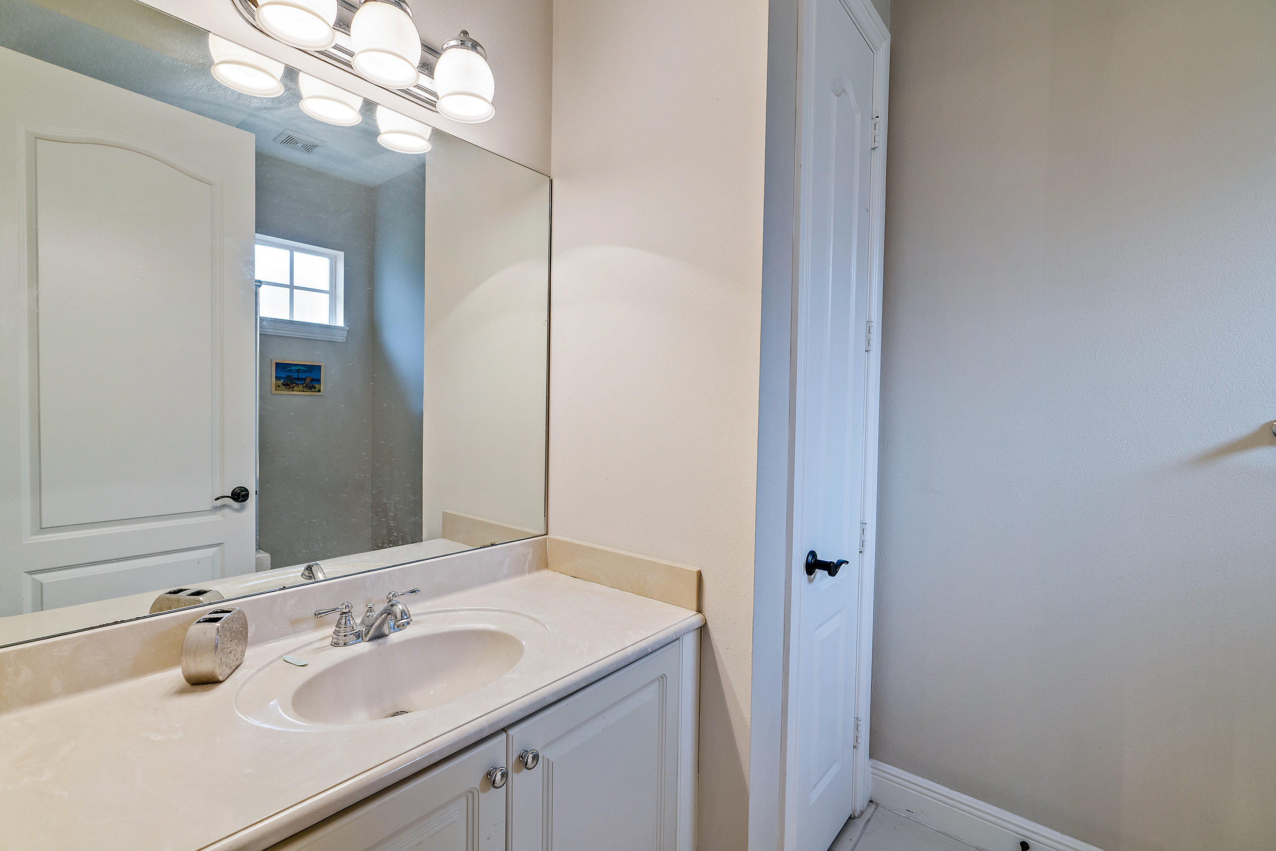 202 Botanica Drive Jupiter, FL 33458 - Photo 33 of 39 a bathroom with a sink and a mirror