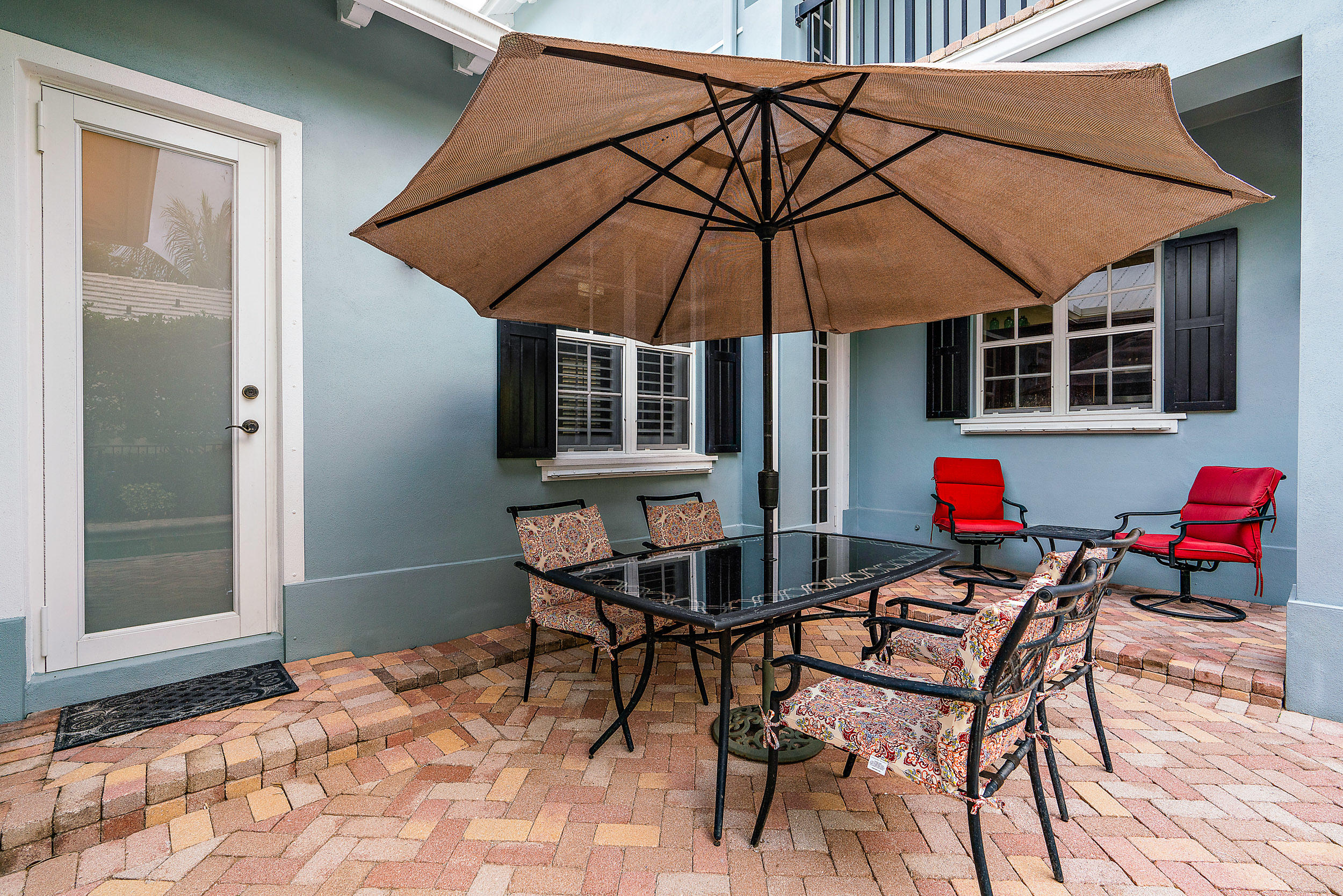 202 Botanica Drive Jupiter, FL 33458 - Photo 35 of 39 a patio with a table and chairs