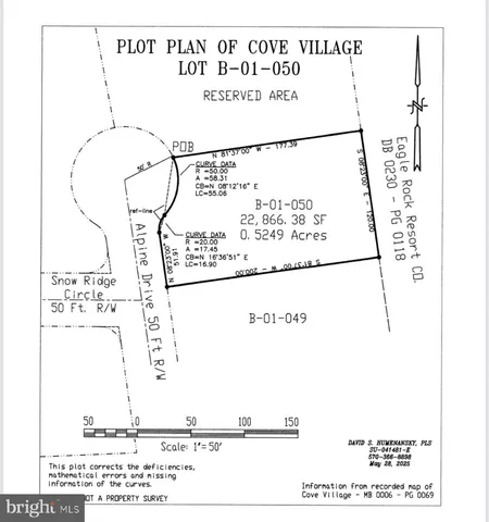 a view of a wooden bench under a tree
