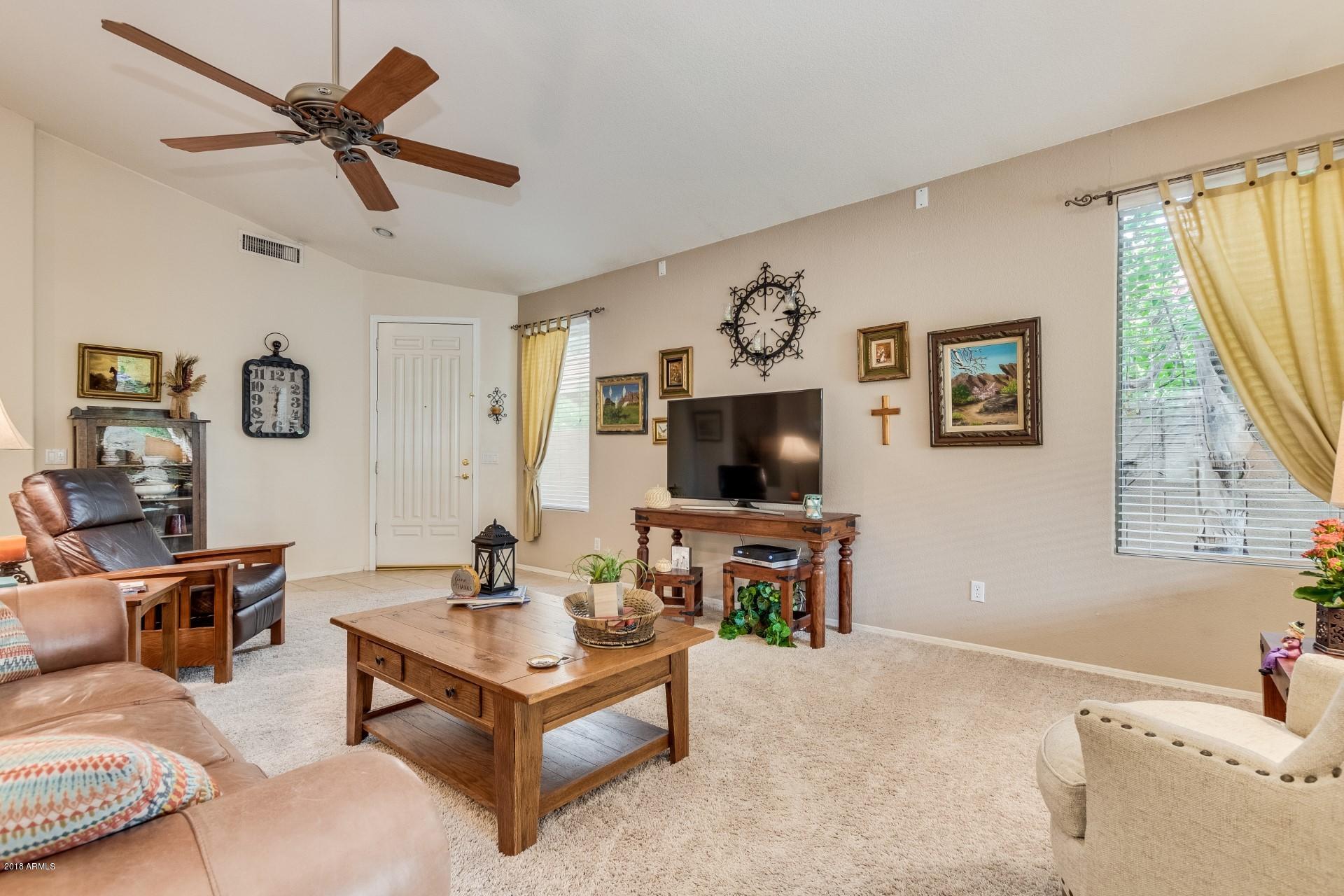 1141 East Ranch Court Gilbert, AZ 85296 - Photo 2 of 22 a living room with furniture and a flat screen tv