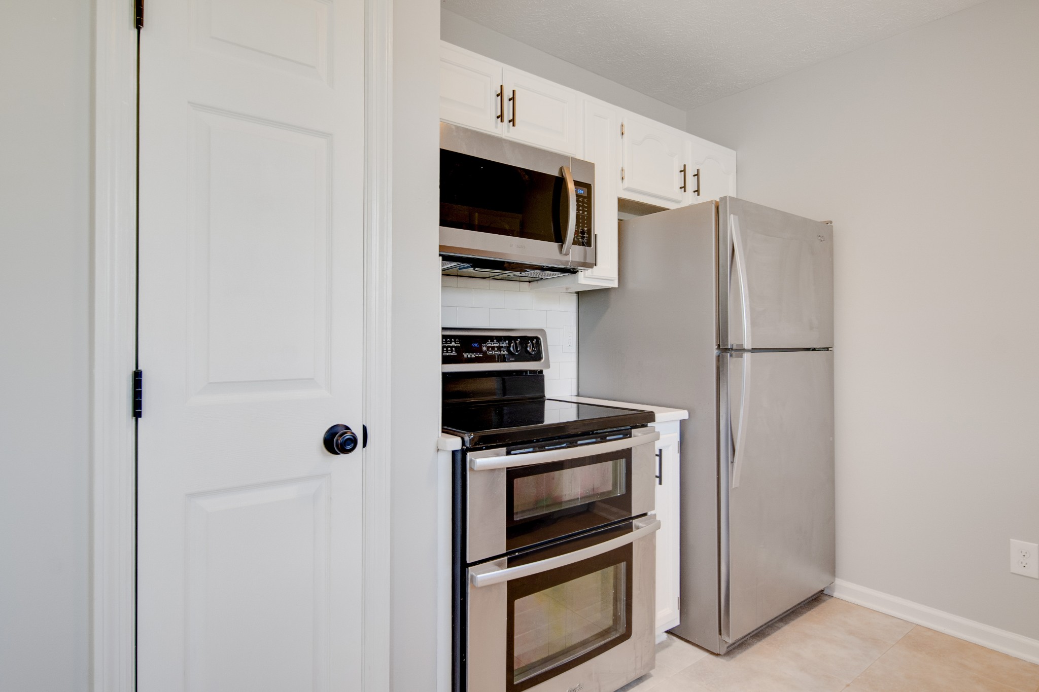 1032 Rock Church Road Dickson, TN 37055 - Photo 11 of 43 a kitchen with stainless steel appliances a refrigerator and a stove top oven