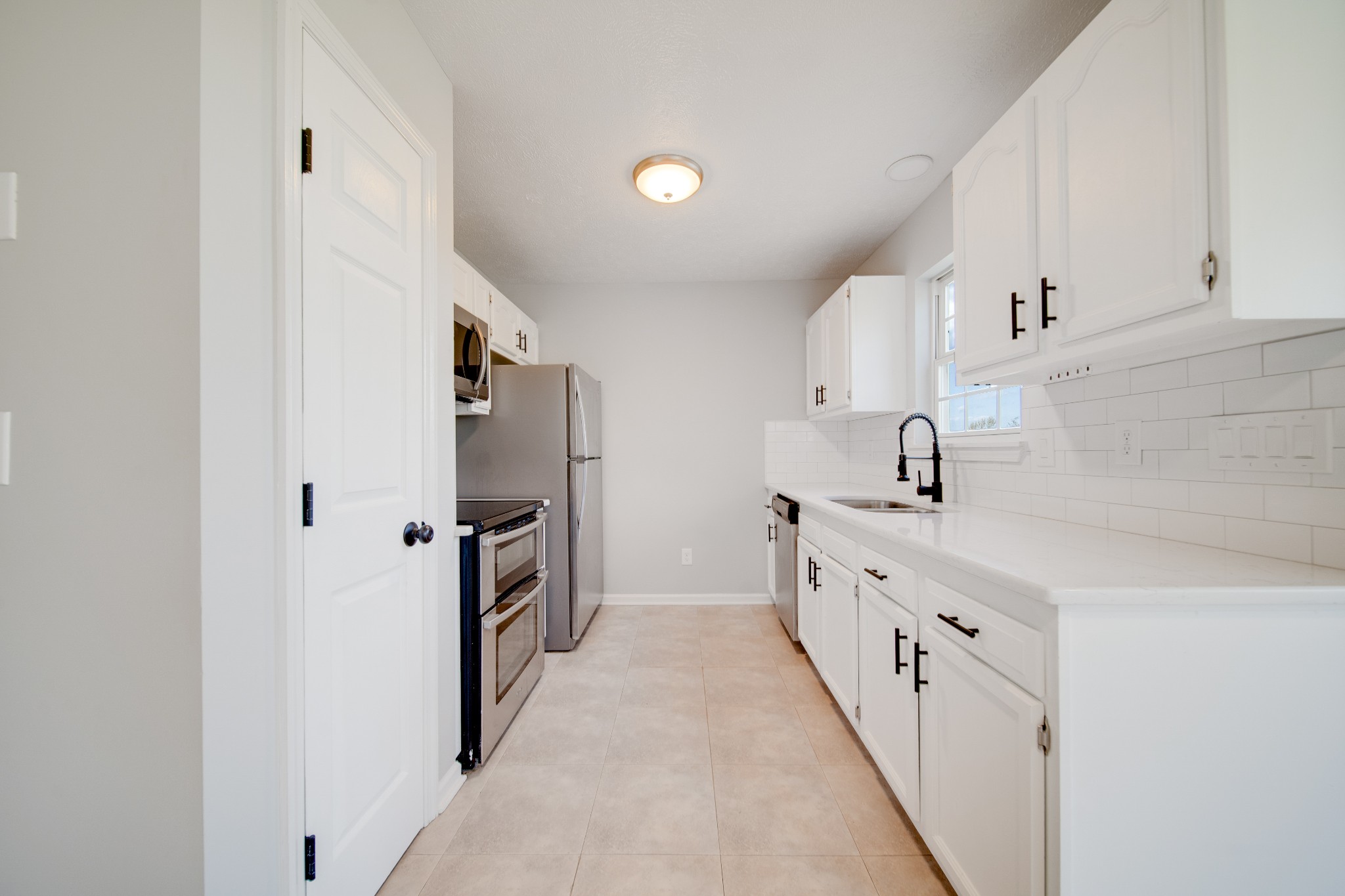 1032 Rock Church Road Dickson, TN 37055 - Photo 12 of 43 a kitchen with granite countertop a sink and stainless steel appliances