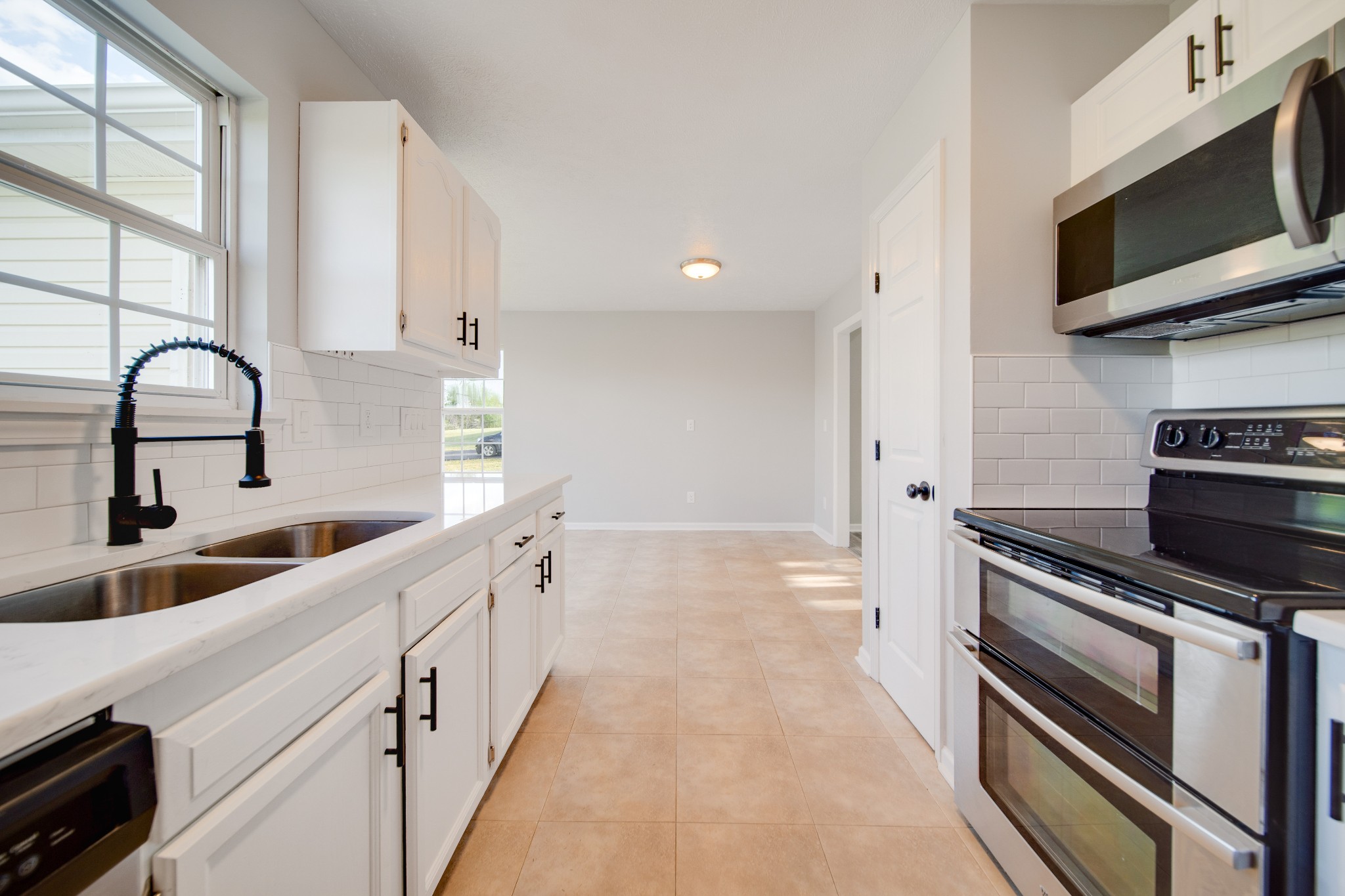 1032 Rock Church Road Dickson, TN 37055 - Photo 13 of 43 a kitchen with stainless steel appliances a stove microwave and sink