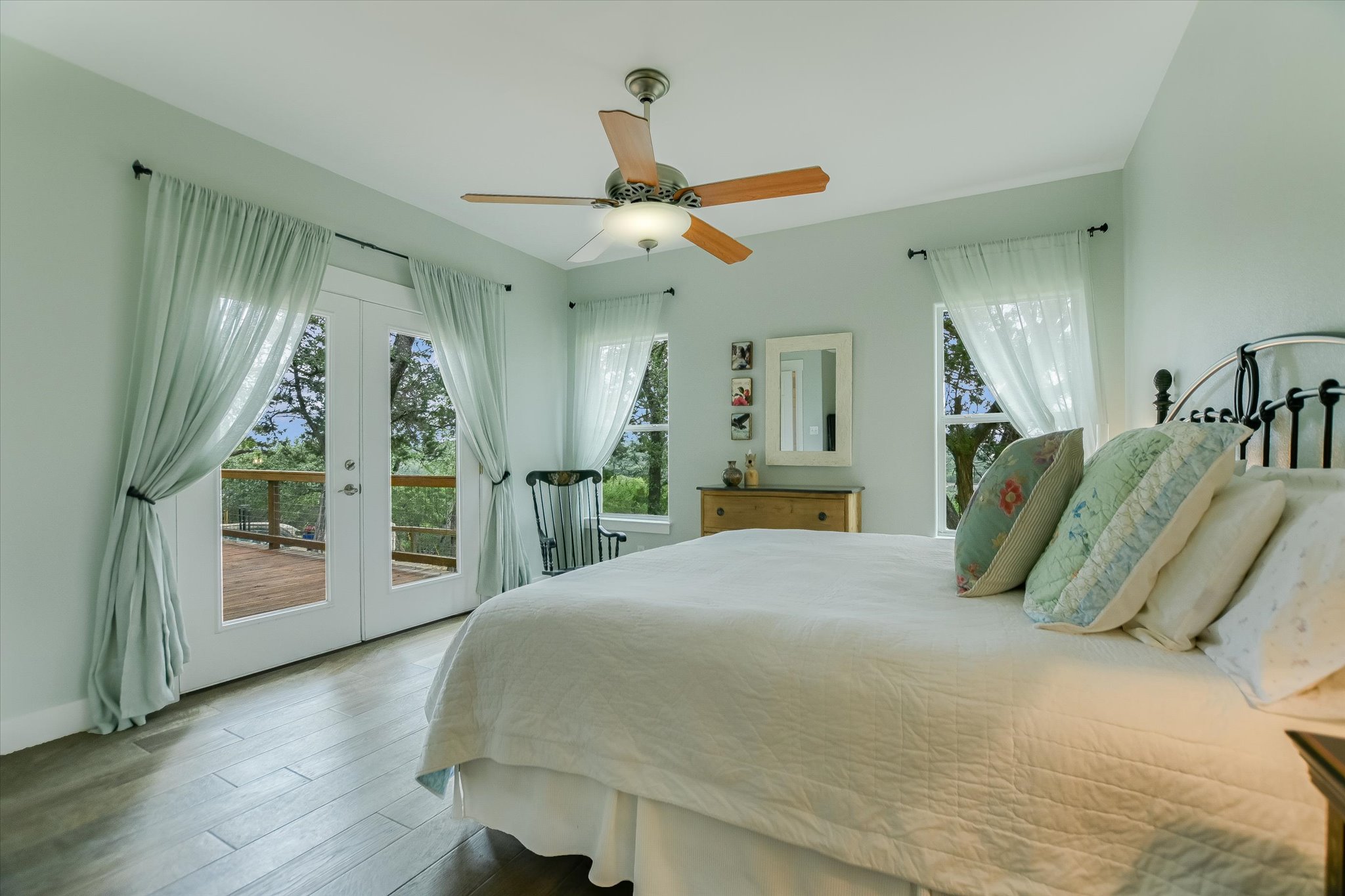 590 Rancho Grande Drive Wimberley, TX 78676 - Photo 18 of 30 a spacious bedroom with a bed mirror and table