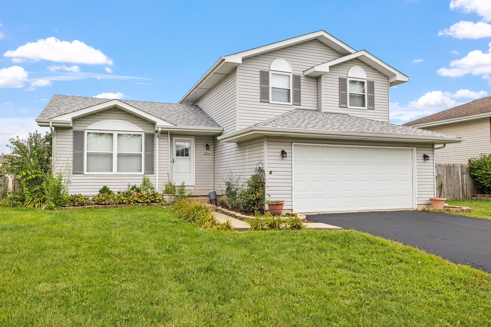 2714 Billie Limacher Lane Plainfield, IL 60586 - Photo 1 of 26 a front view of a house with a yard and garage