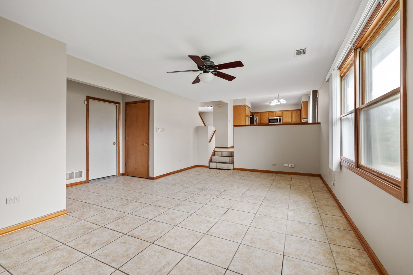2714 Billie Limacher Lane Plainfield, IL 60586 - Photo 11 of 26 an empty room with chandelier fan and windows