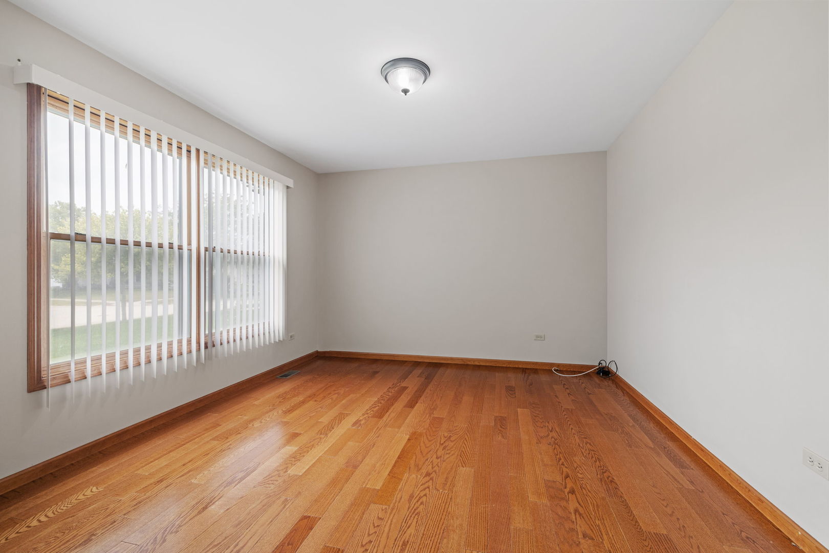 2714 Billie Limacher Lane Plainfield, IL 60586 - Photo 3 of 26 a view of an empty room with wooden floor and a window