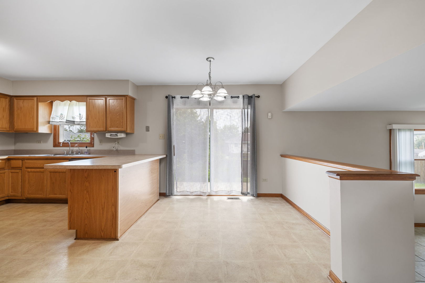 2714 Billie Limacher Lane Plainfield, IL 60586 - Photo 5 of 26 a large kitchen with kitchen island granite countertop a stove a sink dishwasher and a refrigerator