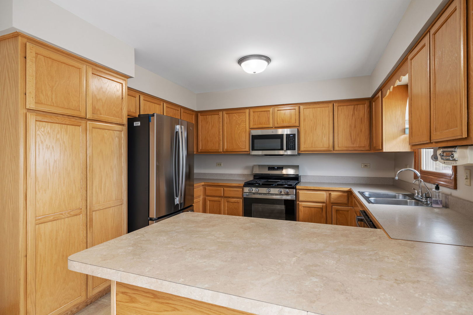2714 Billie Limacher Lane Plainfield, IL 60586 - Photo 6 of 26 a kitchen with stainless steel appliances granite countertop a refrigerator stove top oven a sink and dishwasher