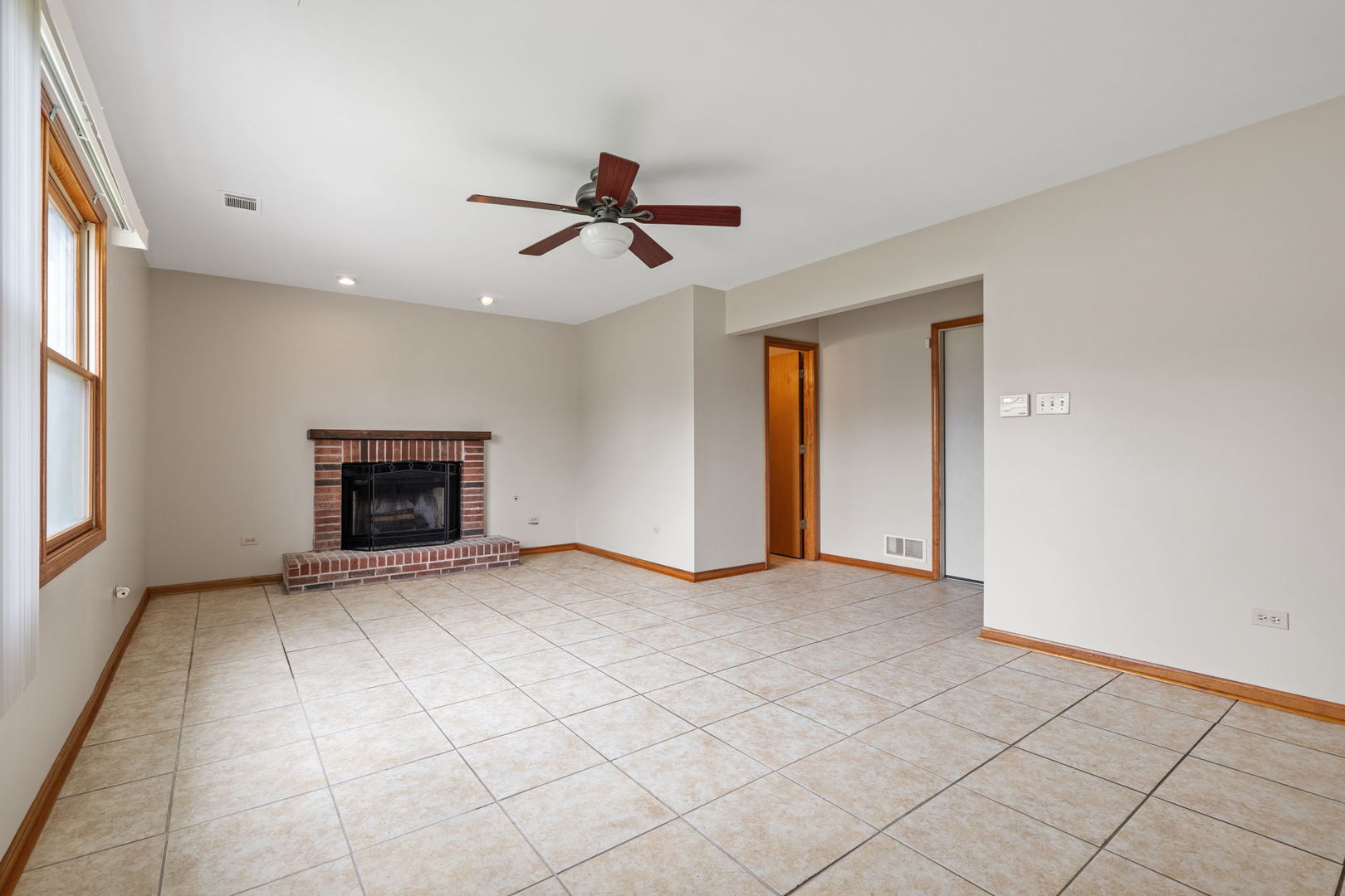 2714 Billie Limacher Lane Plainfield, IL 60586 - Photo 10 of 26 a view of an empty room with a fireplace and a window